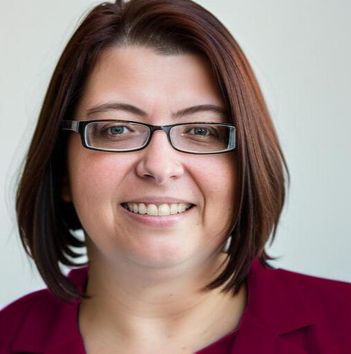 Headshot Christiane Link, a white woman with brown shoulder-long har and black glasses